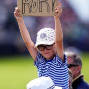 A young spectator shows support for Northern Ireland’s Rory McIlroy on day two of the Open at Royal Portrush (Mike Egerton/PA)